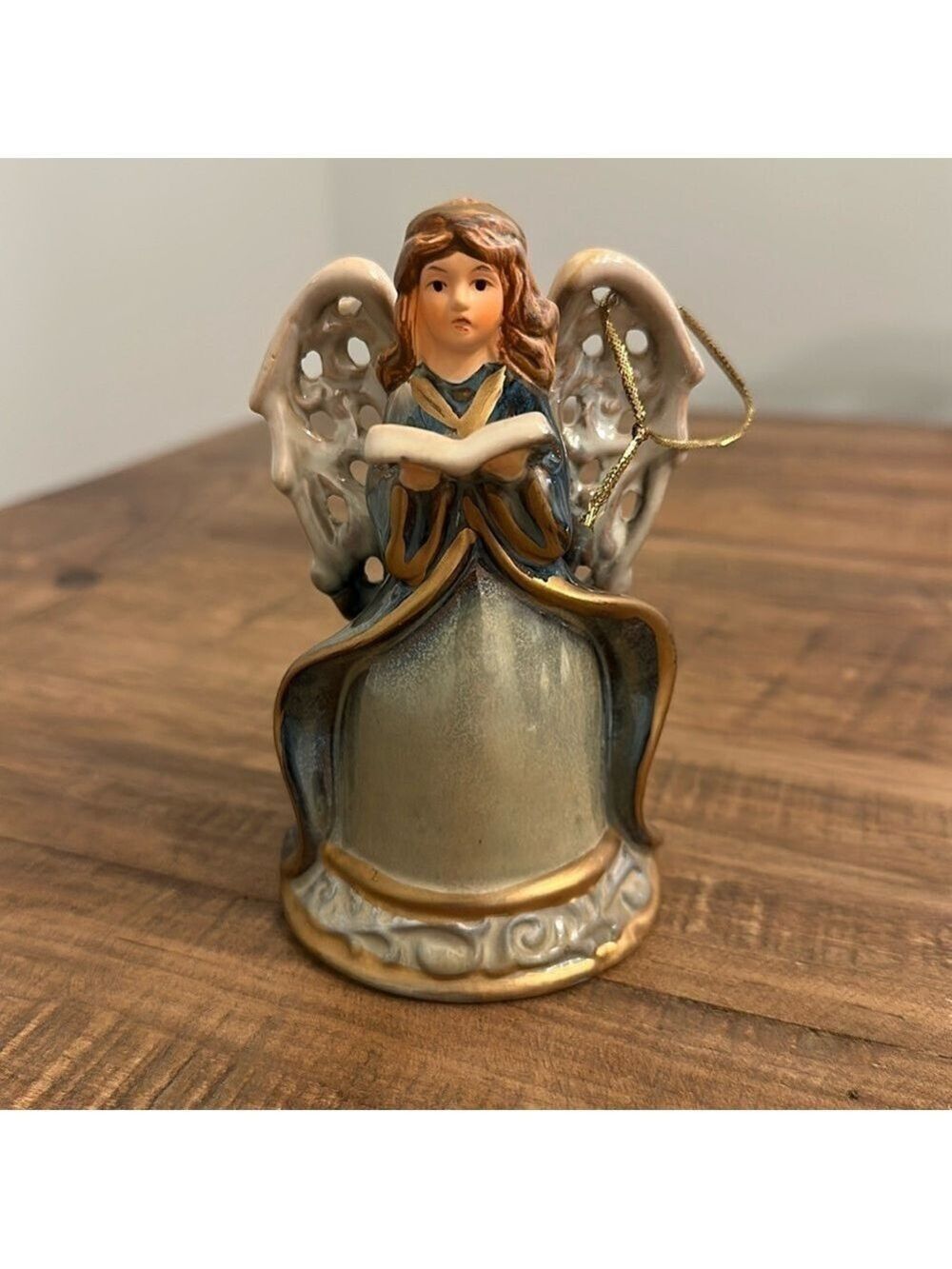 Ceramic Angel Bell. Gold cord attached to the wing, to use as Christmas ornament